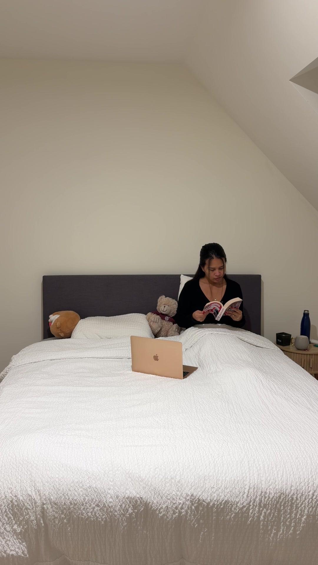 Woman Reading a Book in Bed