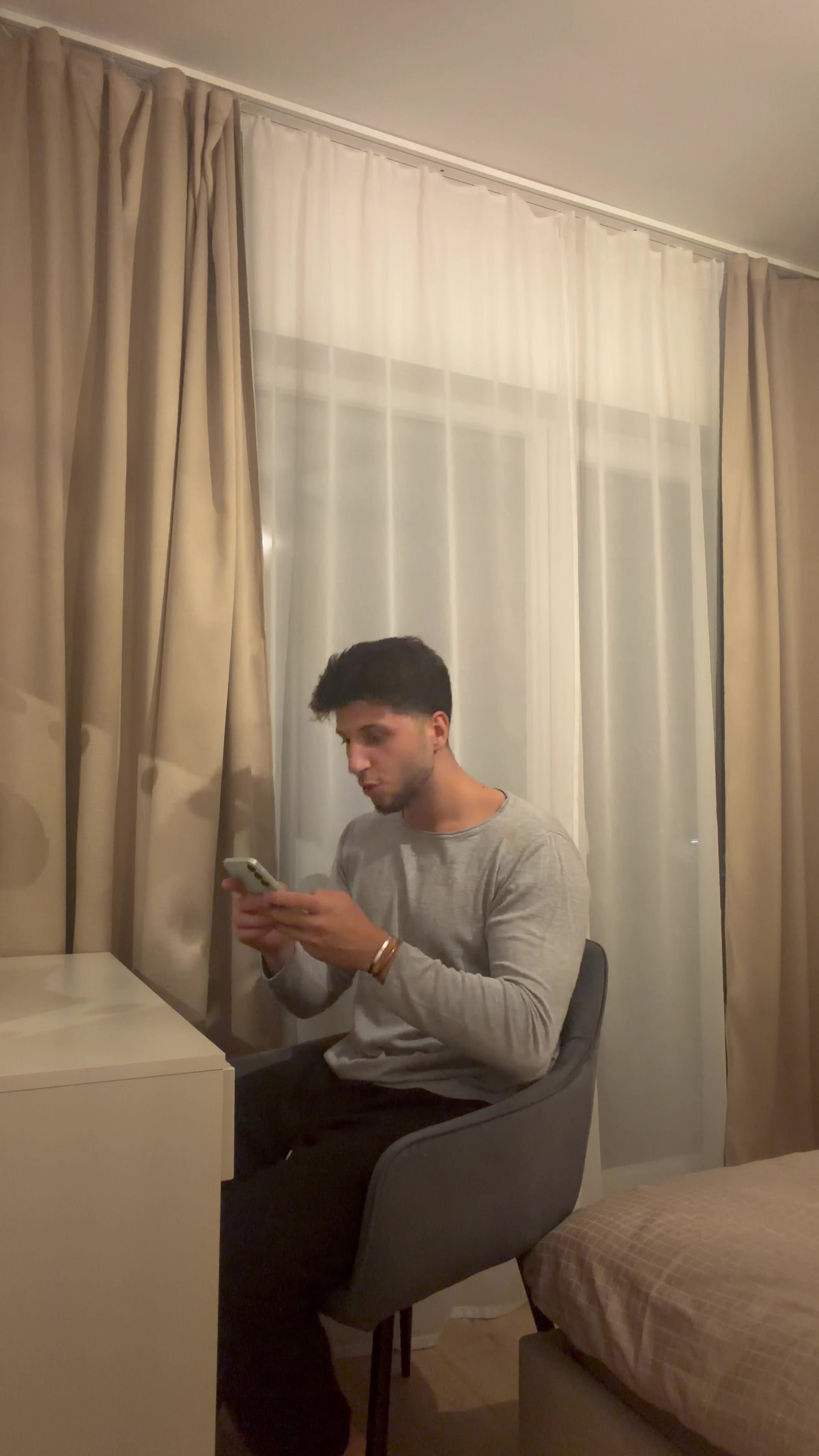 Man Smiling While Texting On Phone