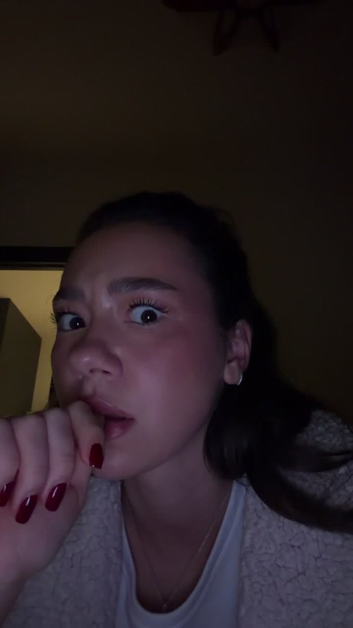Woman Looking Shocked In Dark Room
