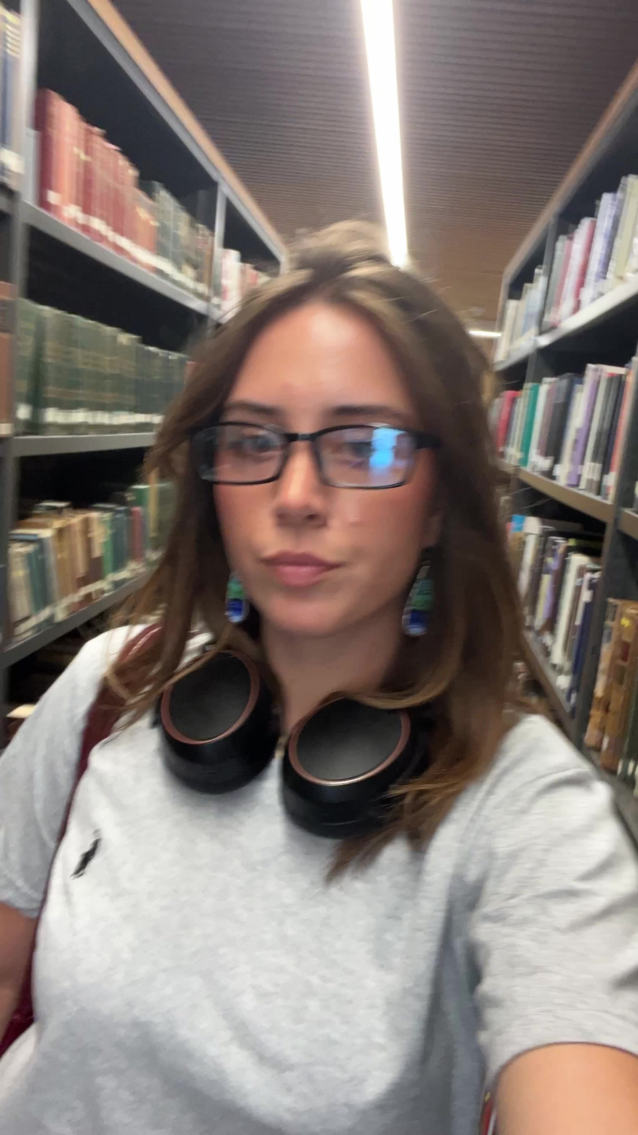 Student Smiling While Walking in Library