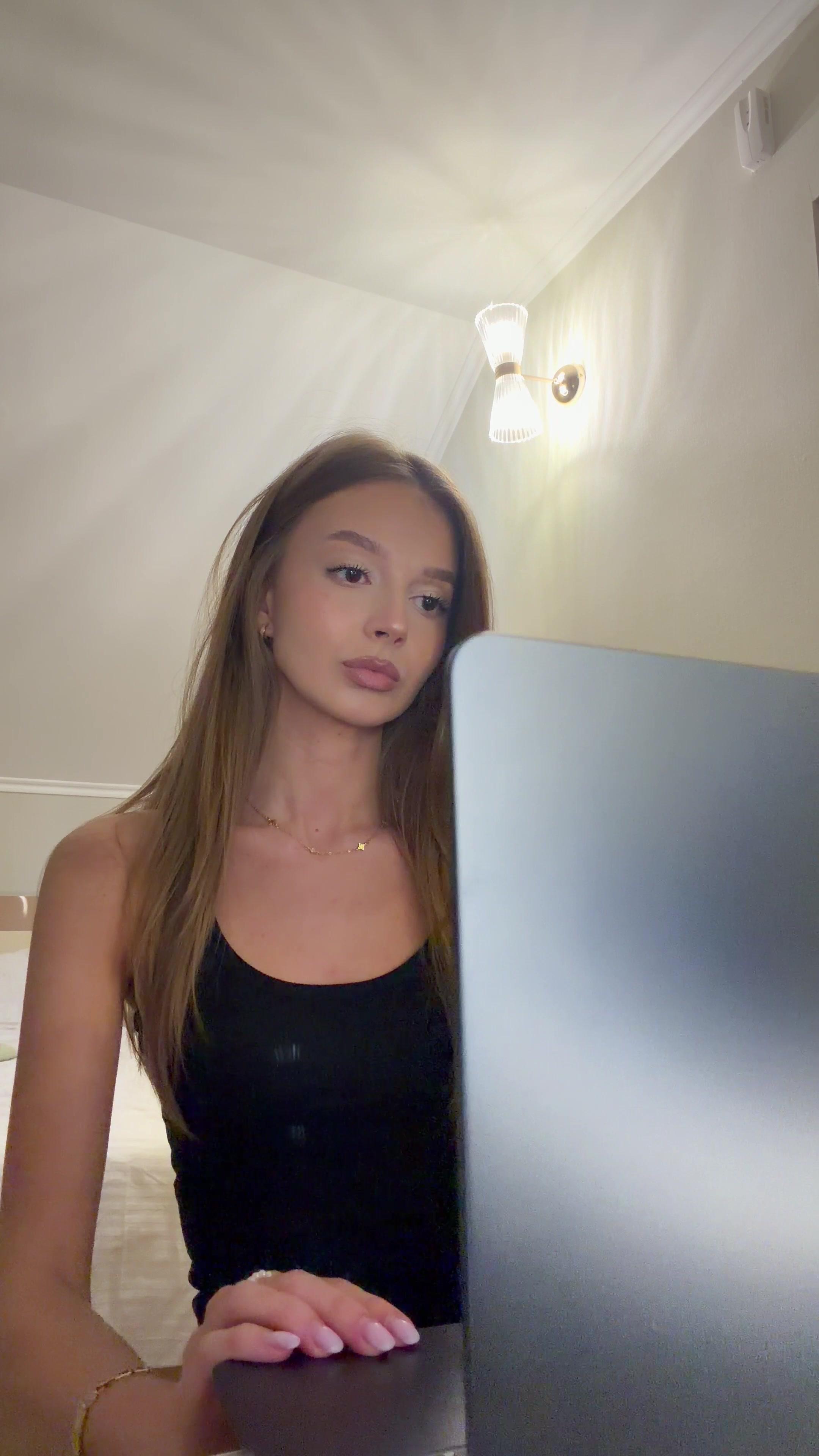 Young Woman Opening Laptop Indoors