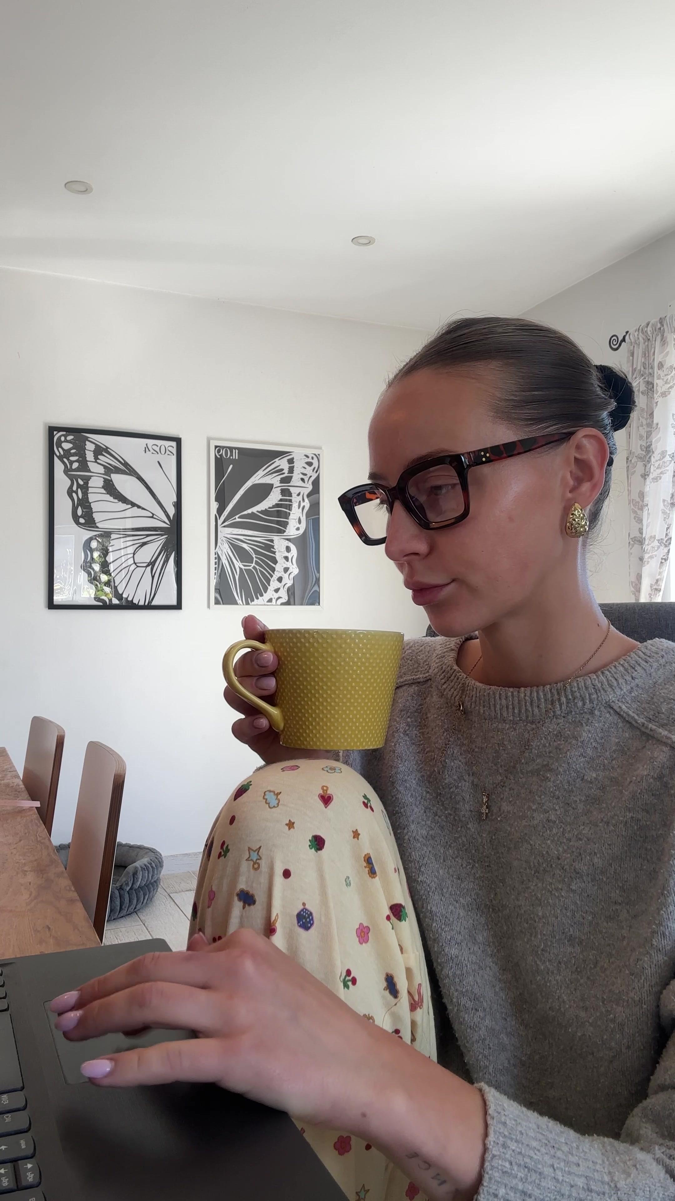 Woman Drinking Tea While Working on Laptop