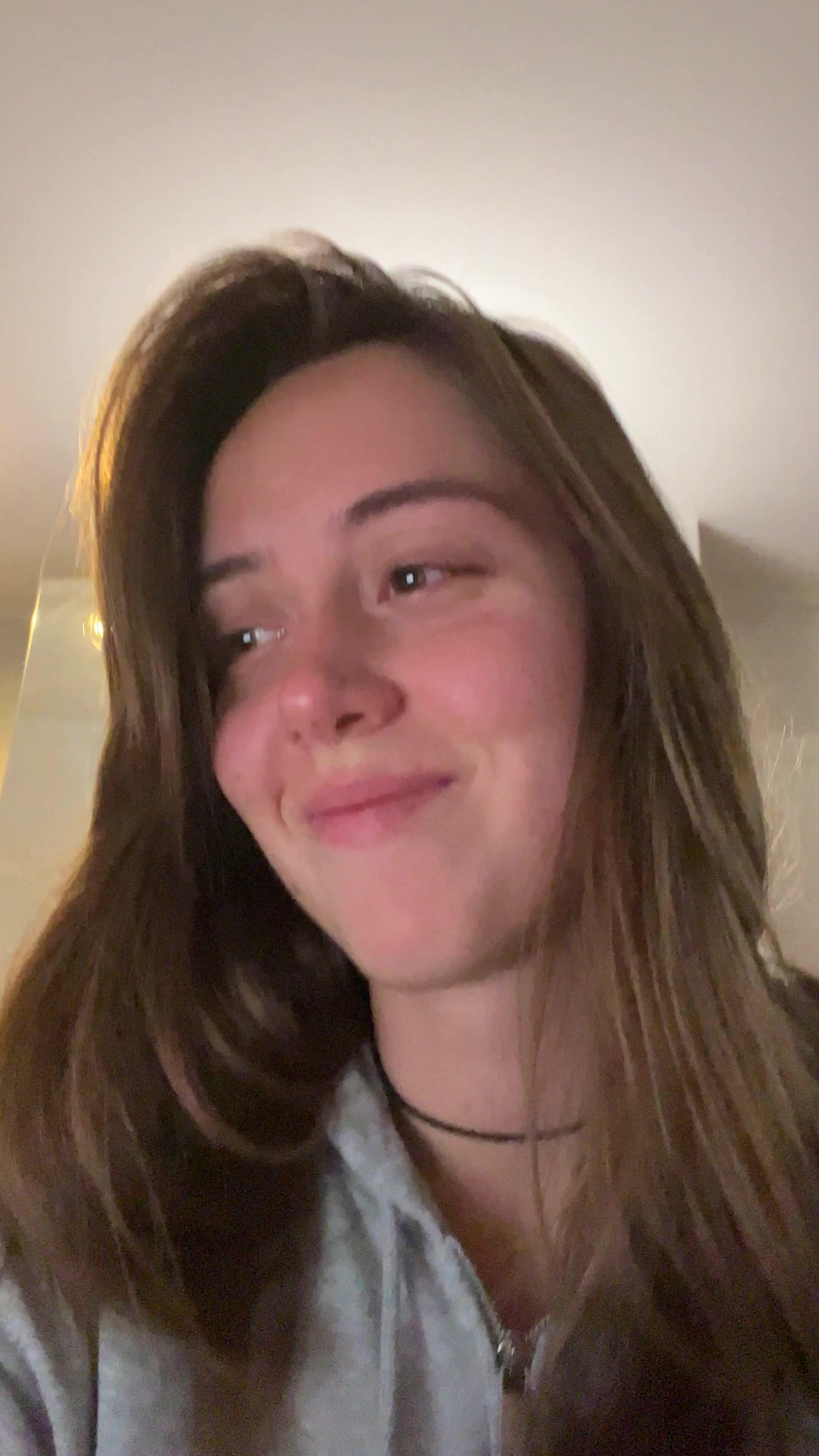 Woman Laughing and Brushing Hair Back