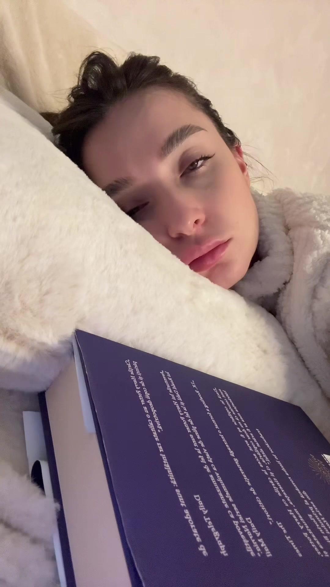 Sleepy Woman Lying In Bed With Book