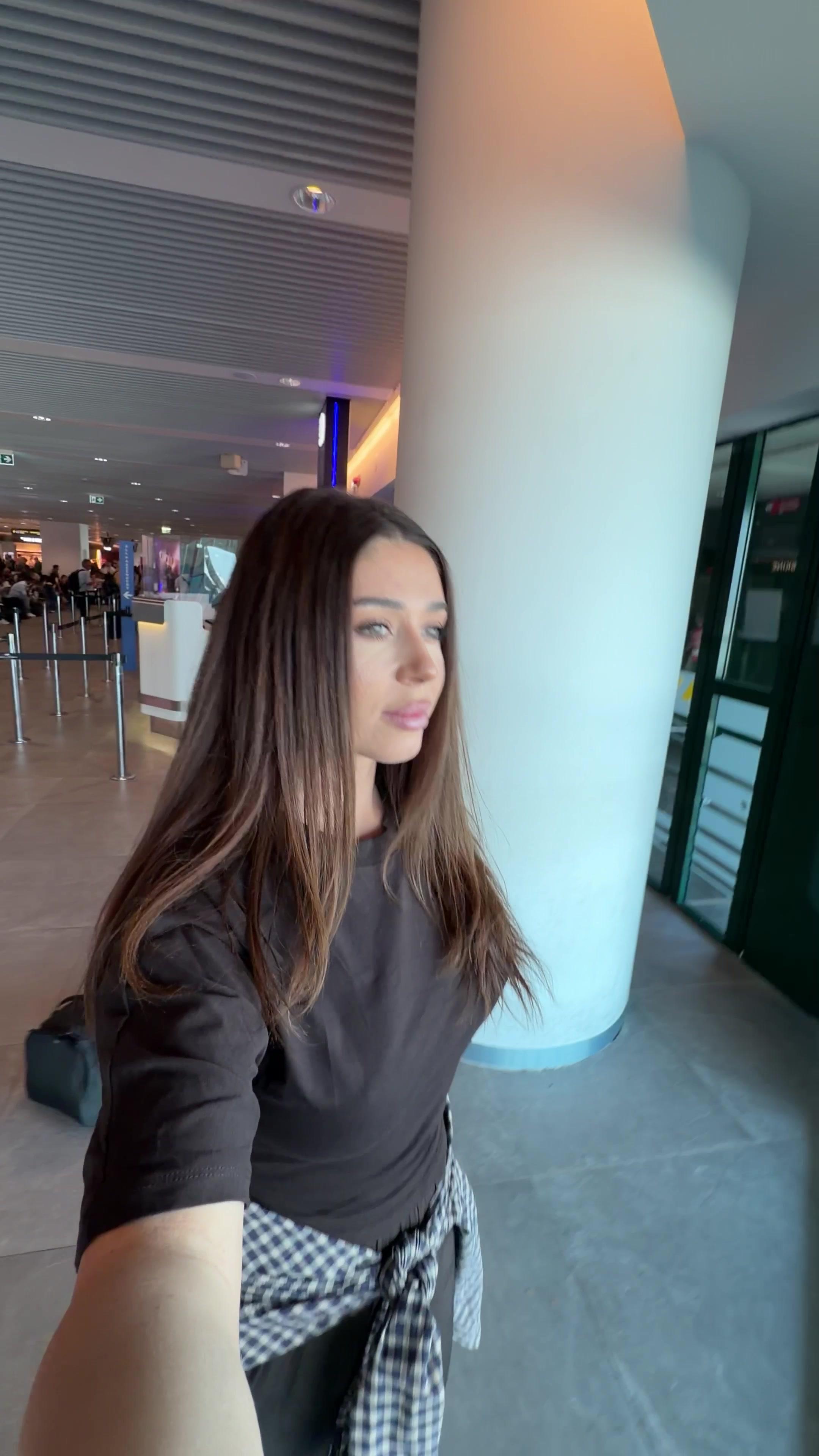 Woman Walking Through Airport Gate Area