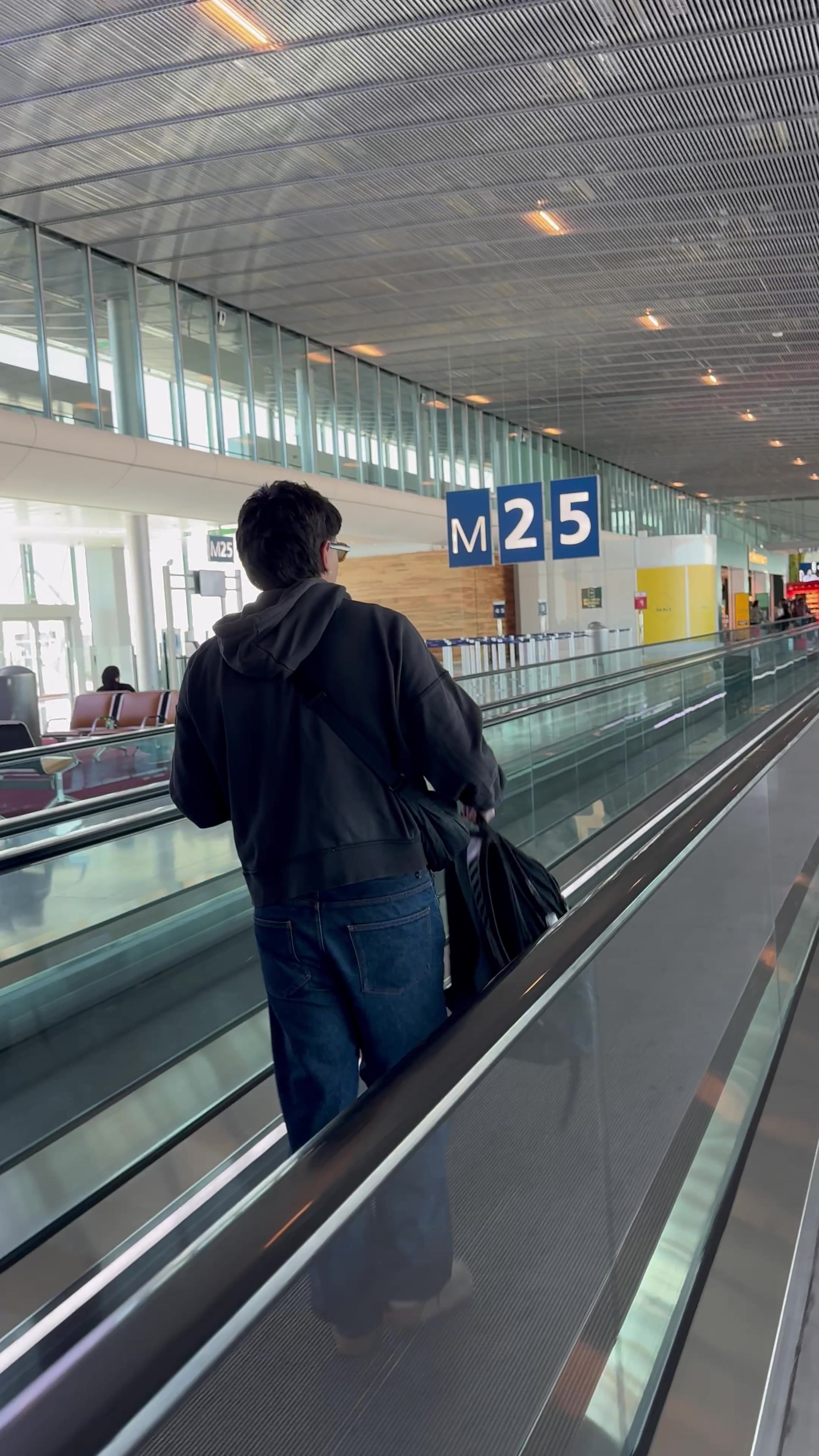 Man Walking on Airport Moving Walkway