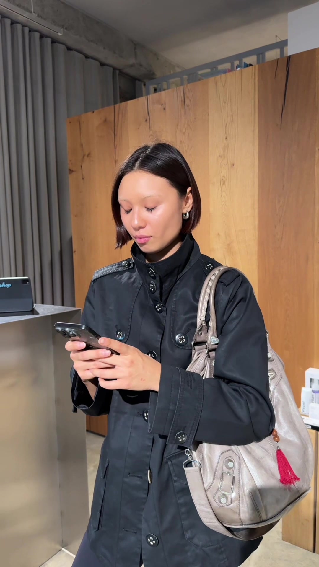 Woman Shocked Looking at Smartphone Indoors