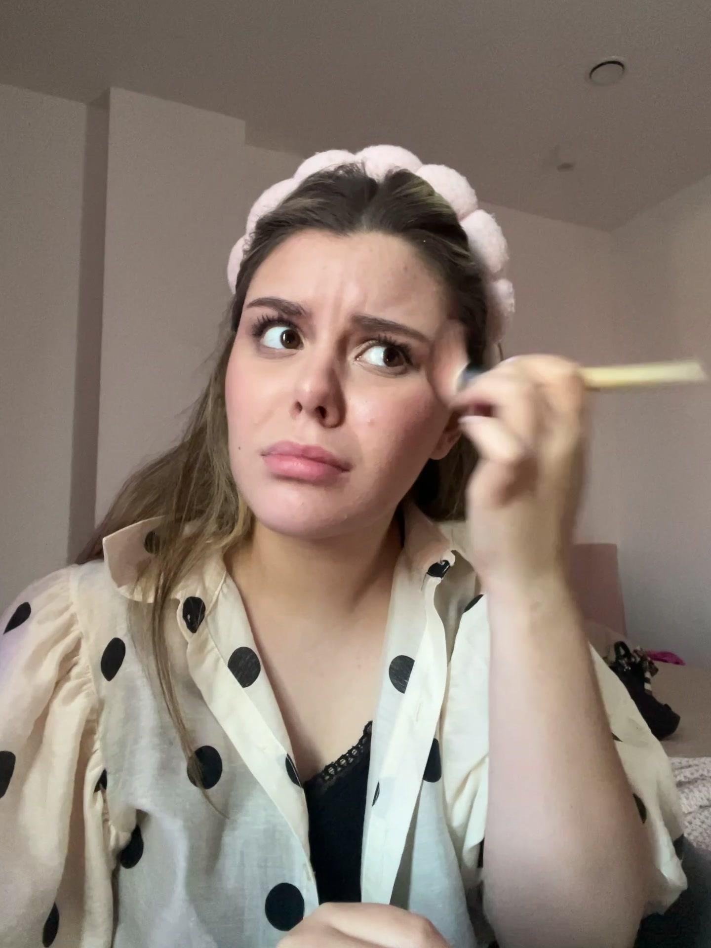 Woman Looking Confused While Applying Makeup