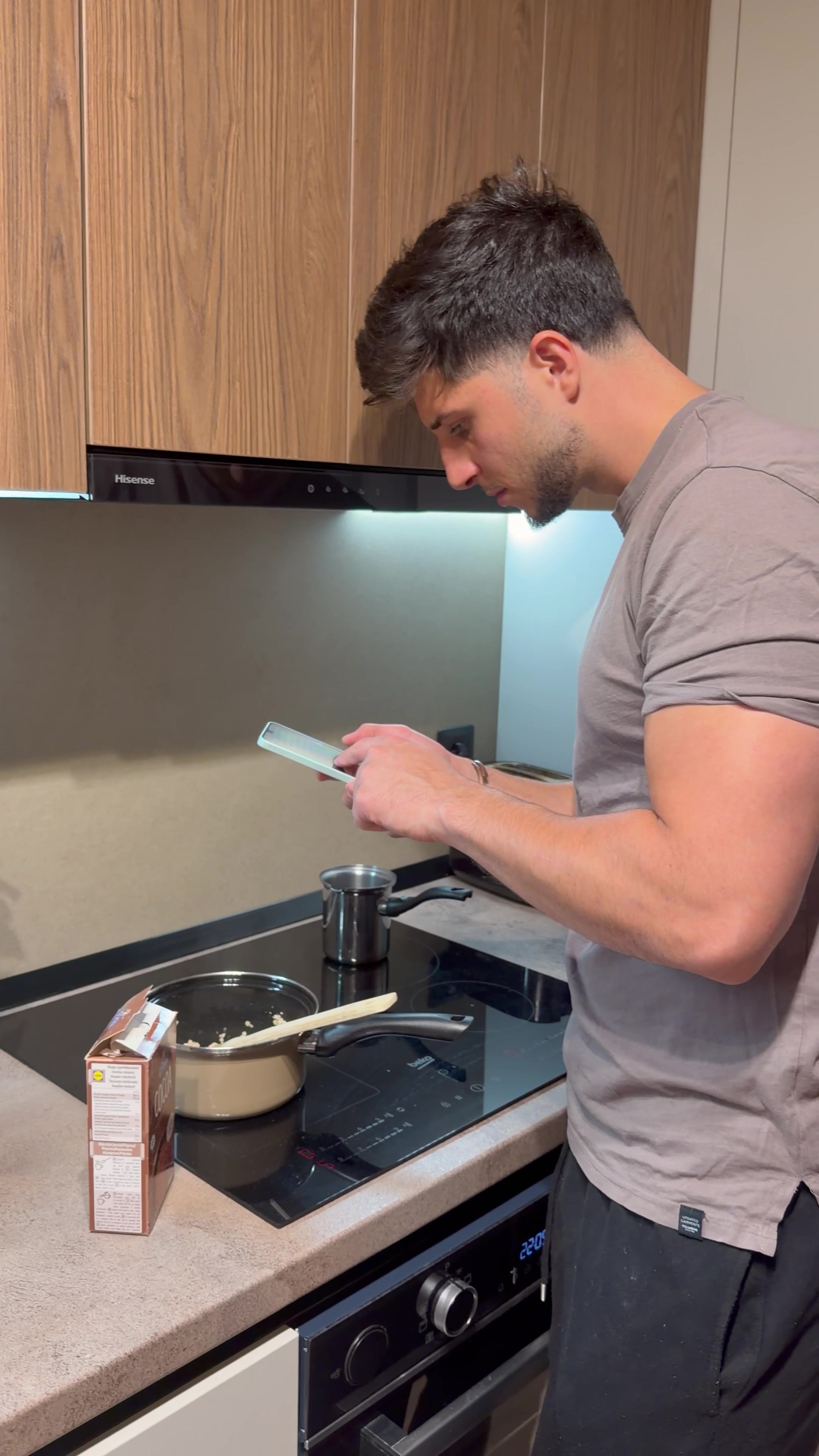 Man Cooking and Checking Smartphone Recipe