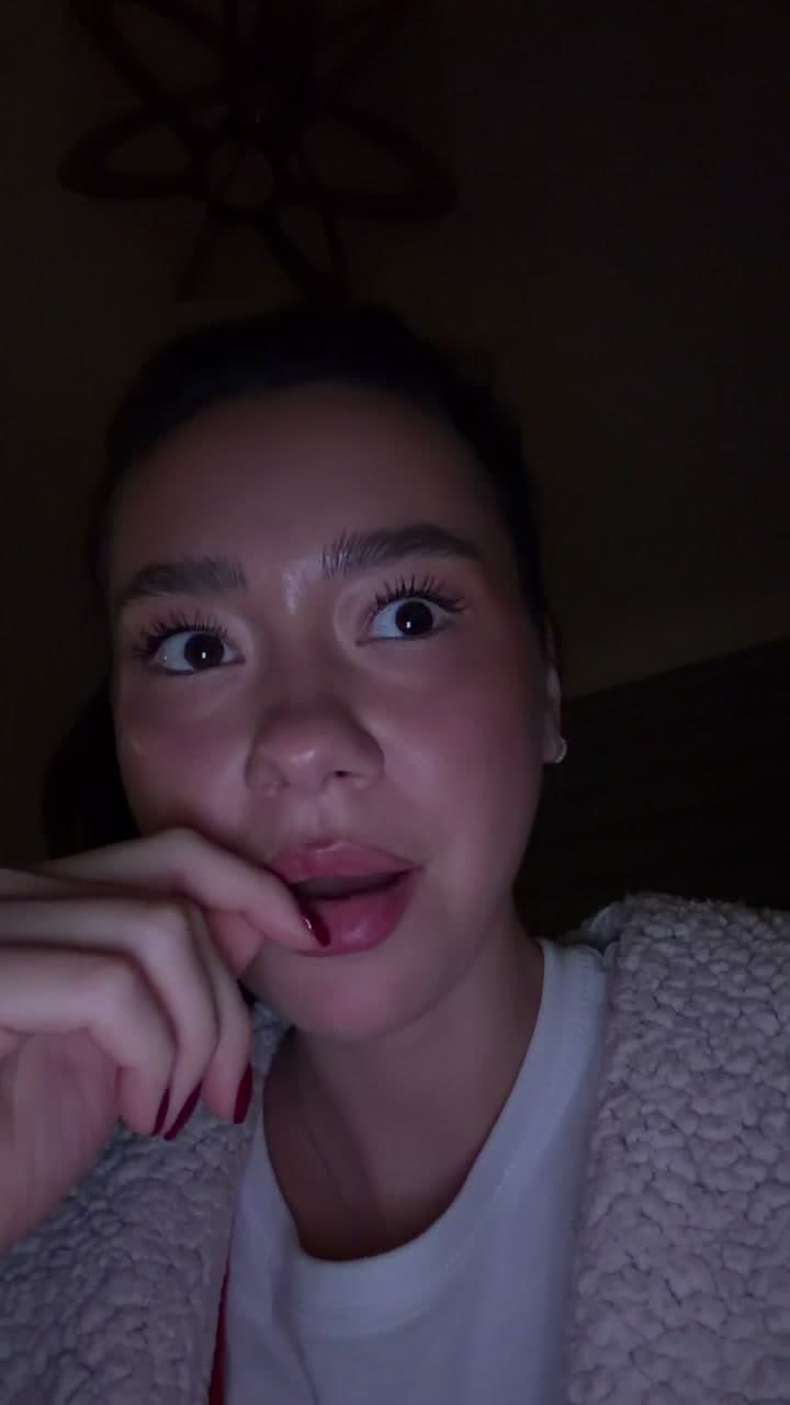 Woman Reacting With Shock In Dim Room