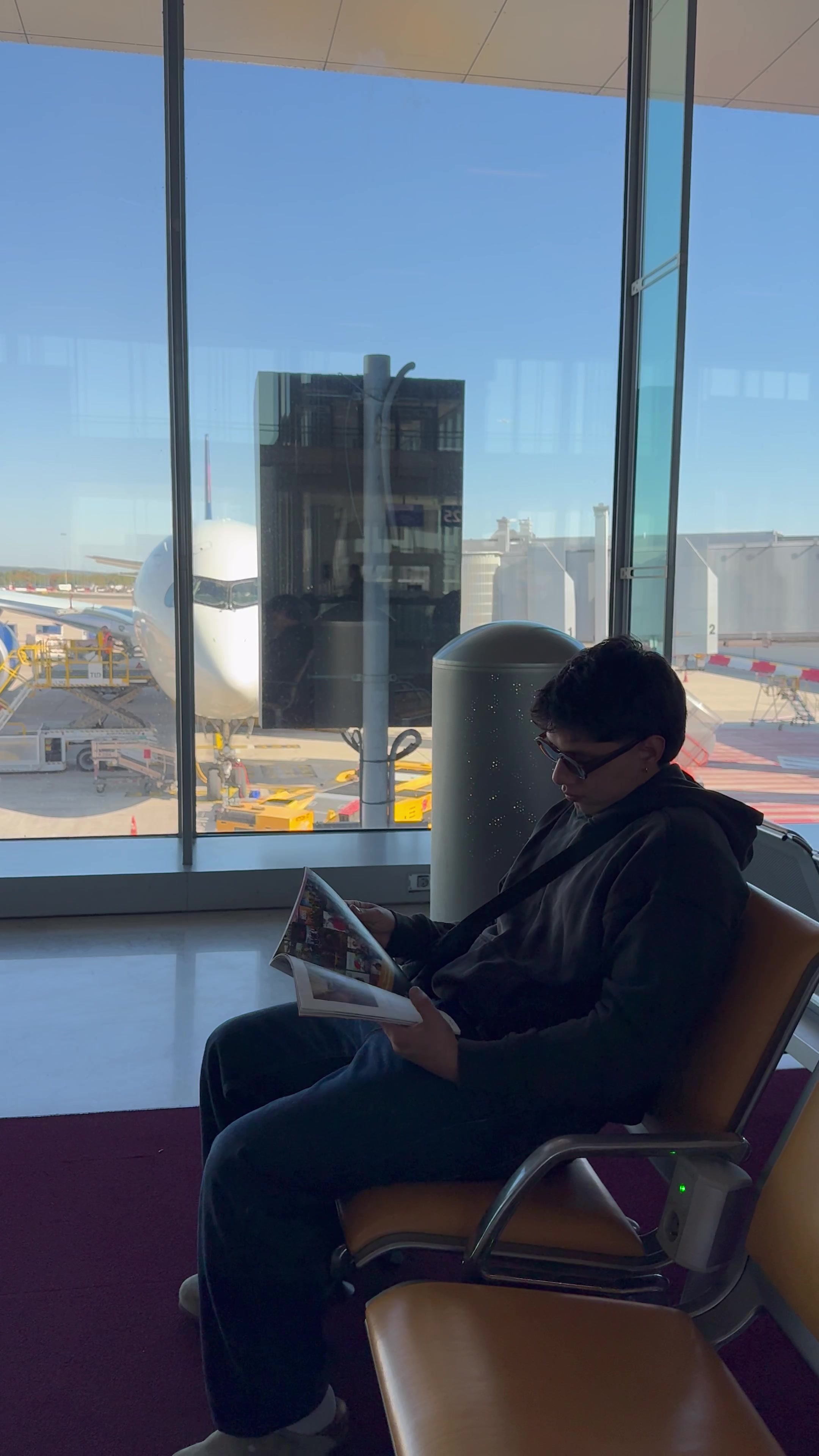 Man Reading Magazine at Airport Gate