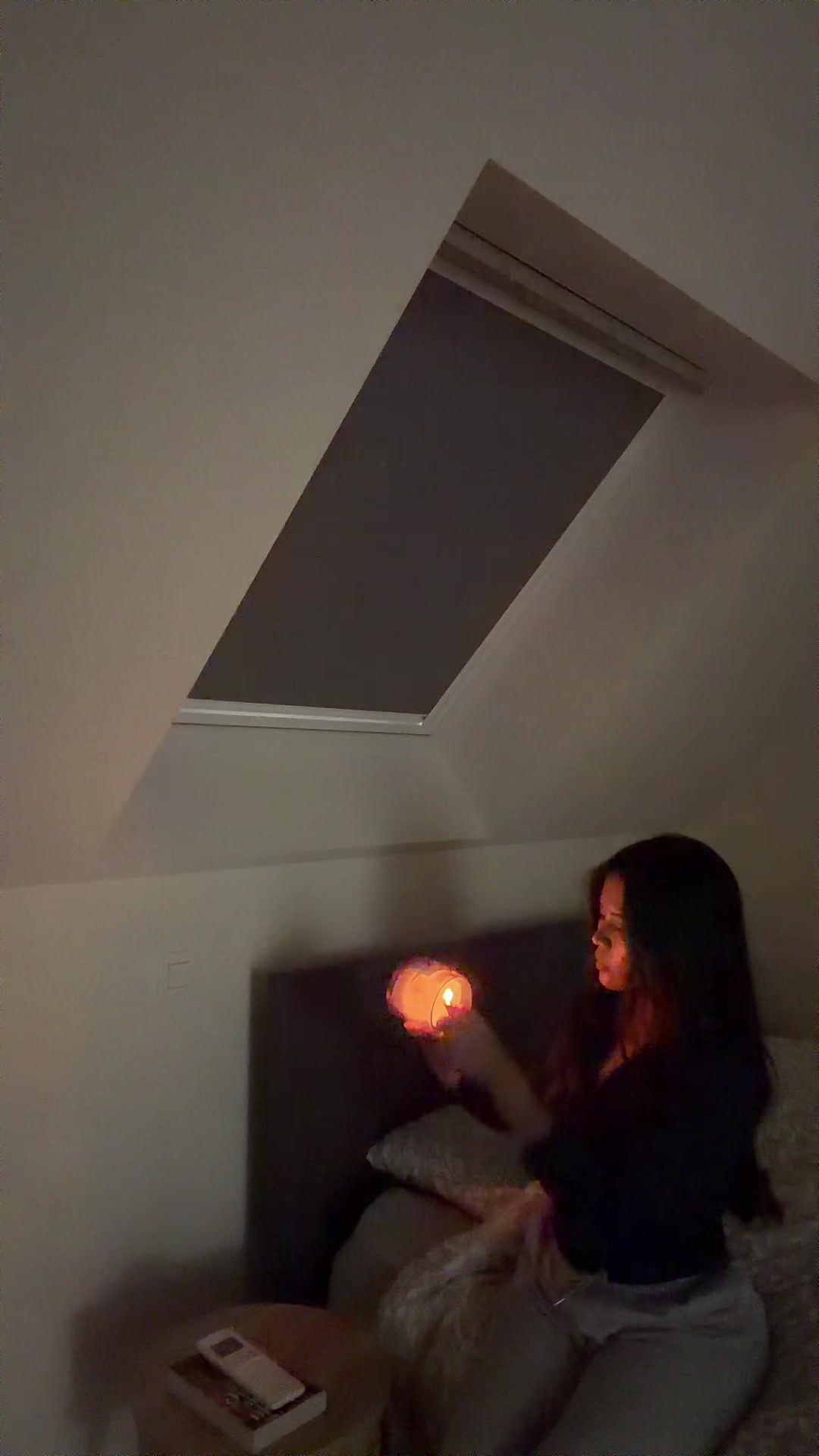 Ash Lights Candle in Cozy Bedroom