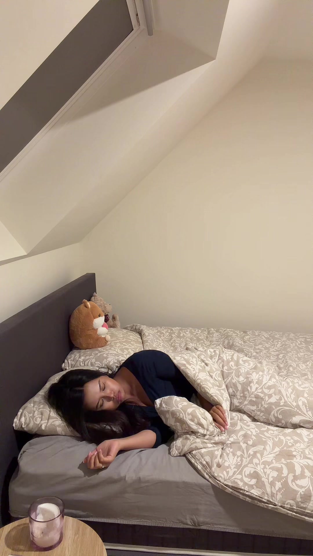Woman sleeping pulls blanket over head