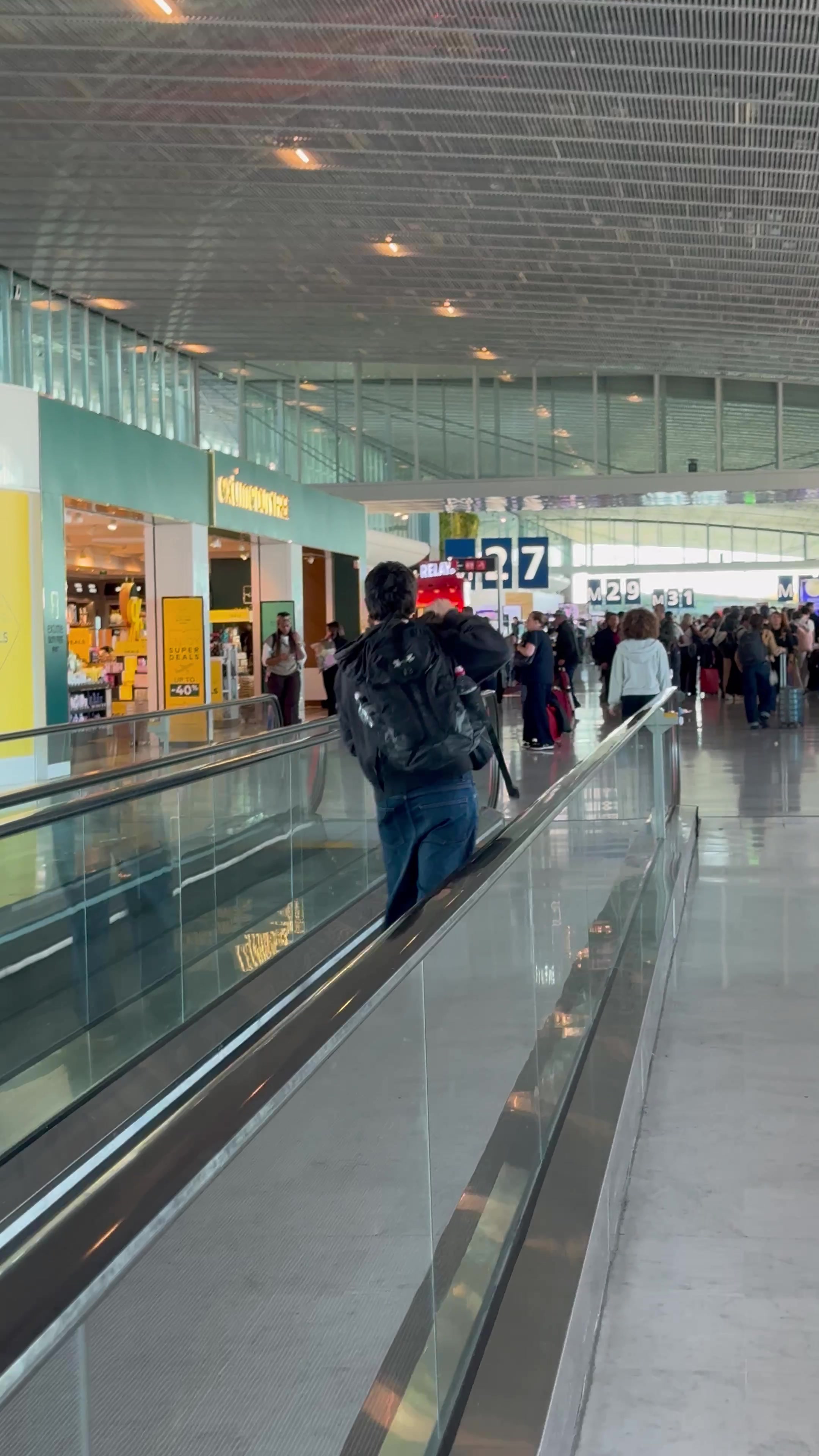 Man Riding Moving Walkway at Airport